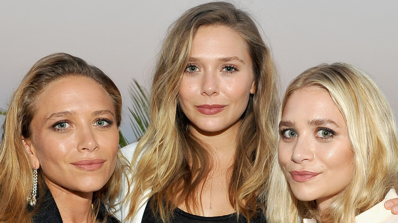 Elizabeth Olsen with her sisters Mary-Kate and Ashley Olsen