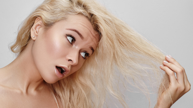 Woman looking at bleached hair