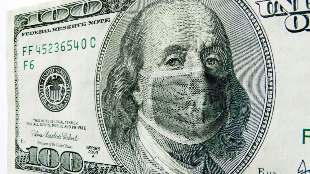 ben franklin on $100 bill with face mask