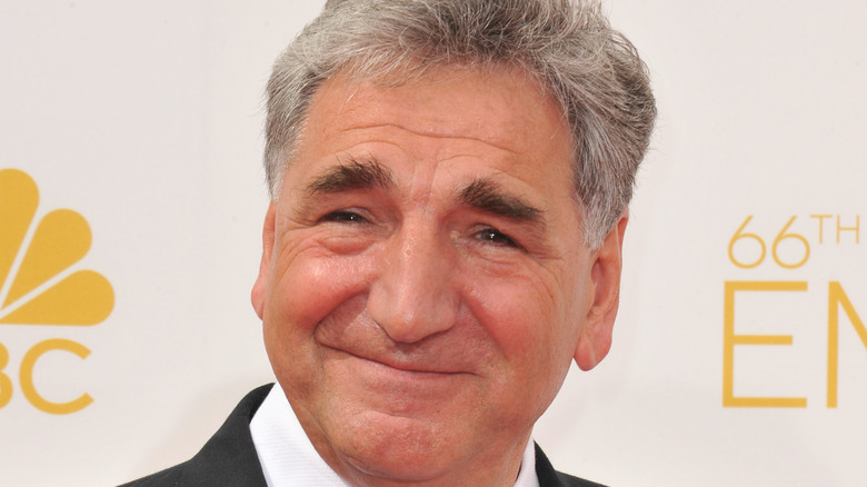 Jim Carter smiling at red carpet event 