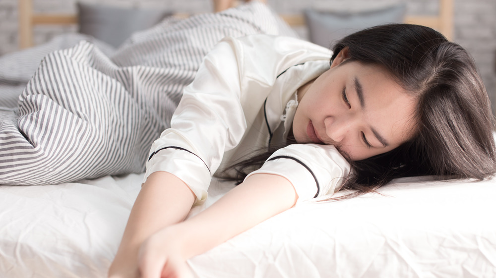 Woman asleep without a pillow