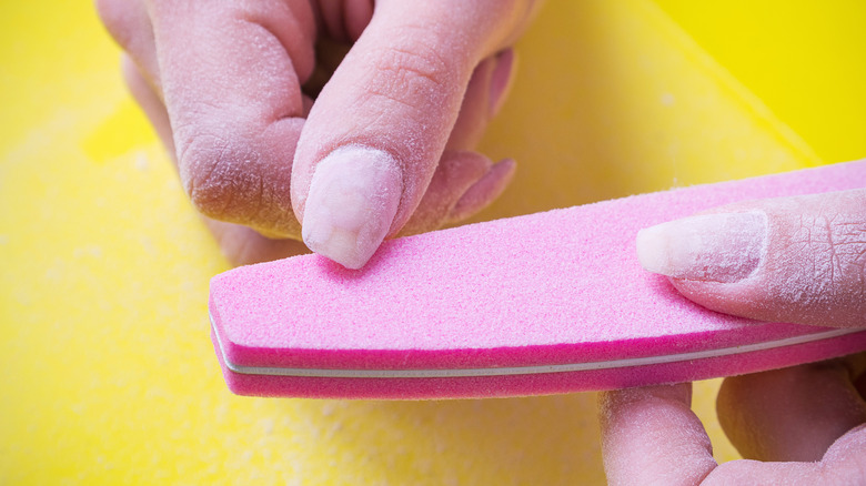 Woman filing her nails