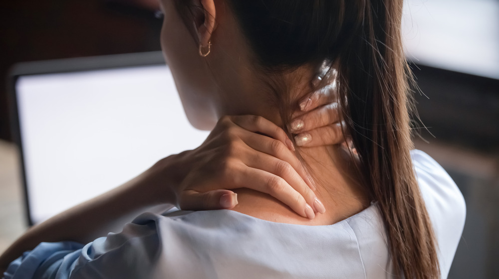 Woman massaging her neck