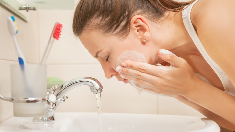 Woman washing her face