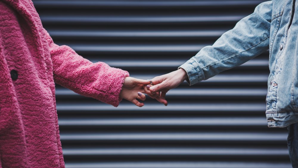 Couple holding hands