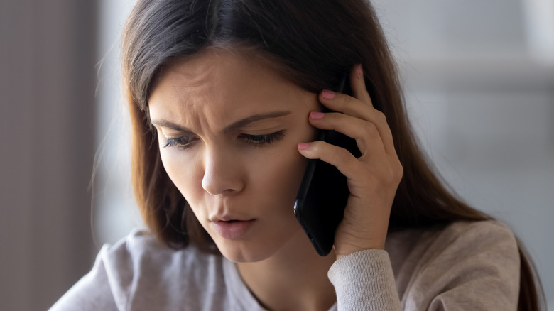 Woman concerned on the phone 