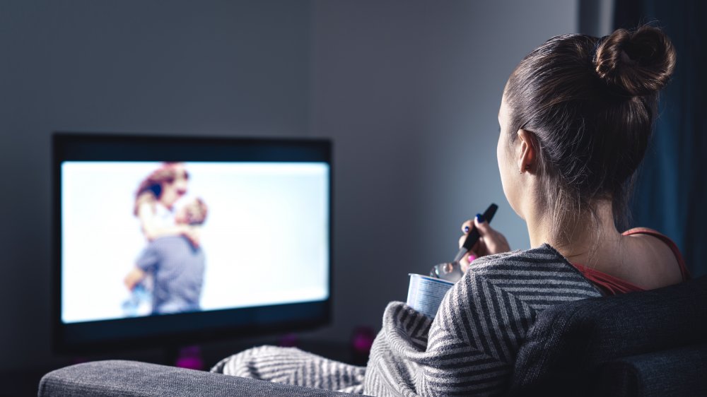 woman eating while watching TV