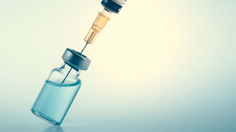 Syringe in a bottle of liquid
