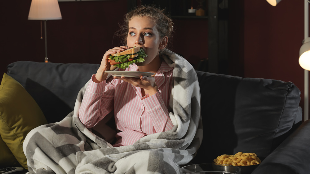 Woman snacking at night