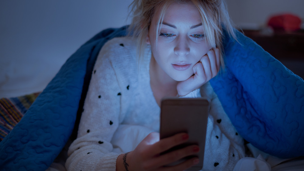 Woman on her phone in bed