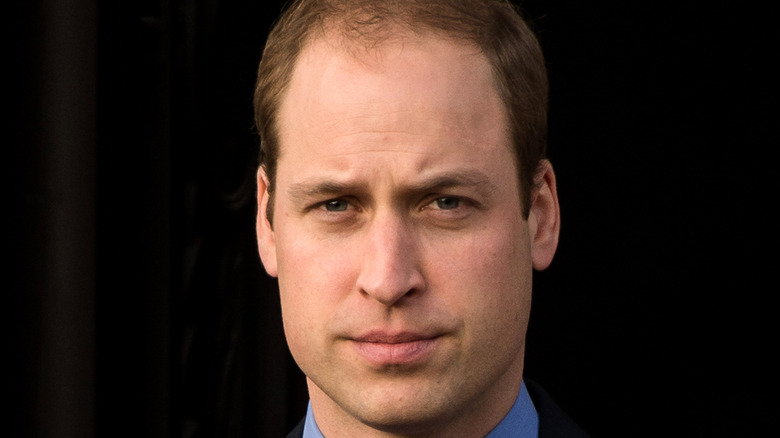 Prince William wears a suit.