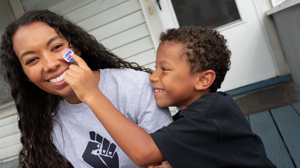 Mother with son and an "I voted" sticker