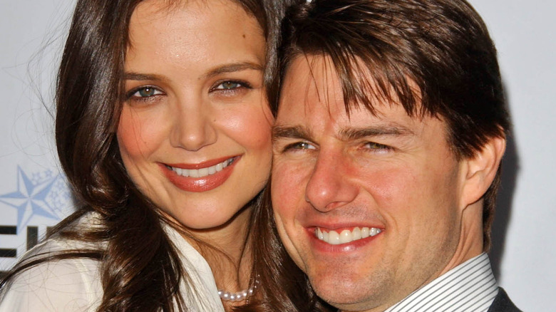 Katie Holmes and Tom Cruise posing on the red carpet