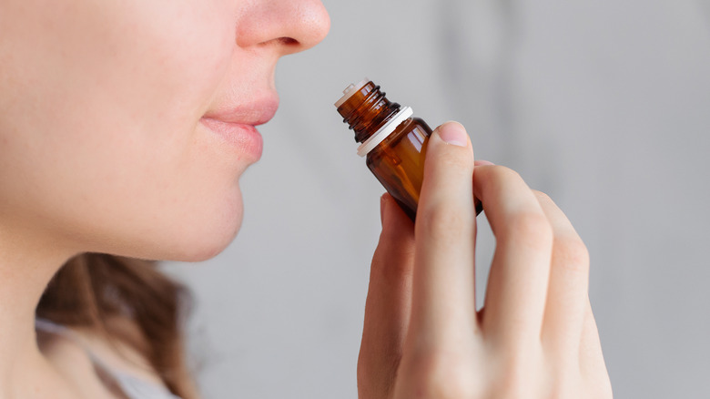 Woman smelling an essential oil