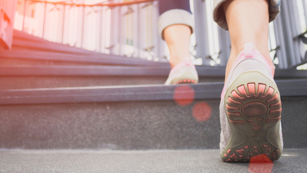 Woman running stairs in sneakers