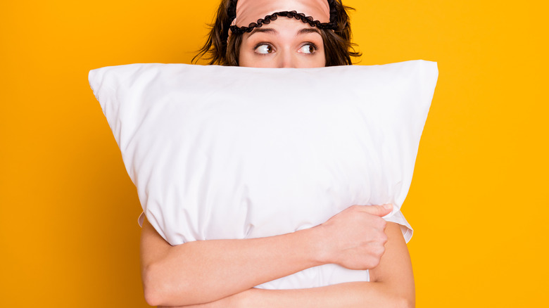 scared woman holding pillow