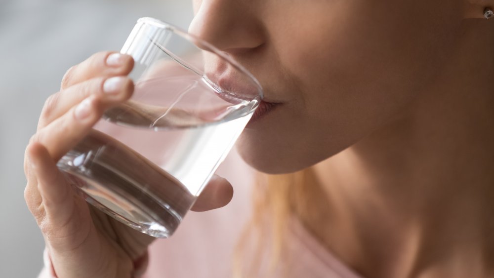Close-up of woman drinking a glass of water