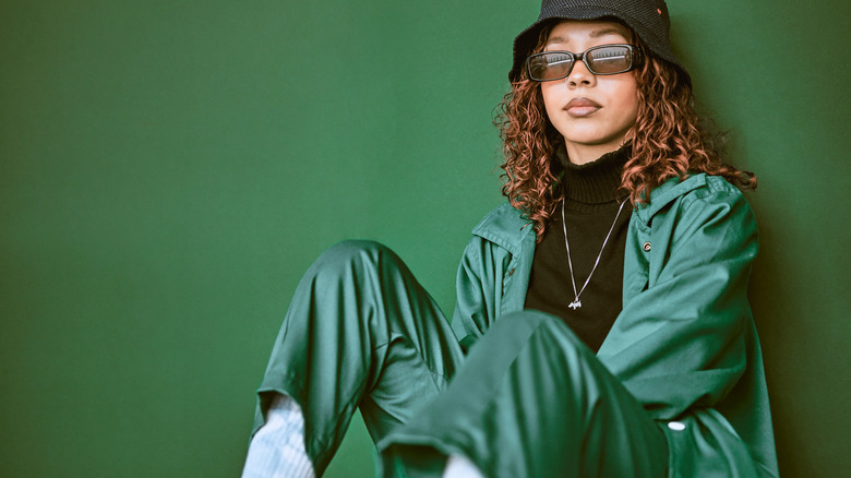 Woman sitting in green outfit