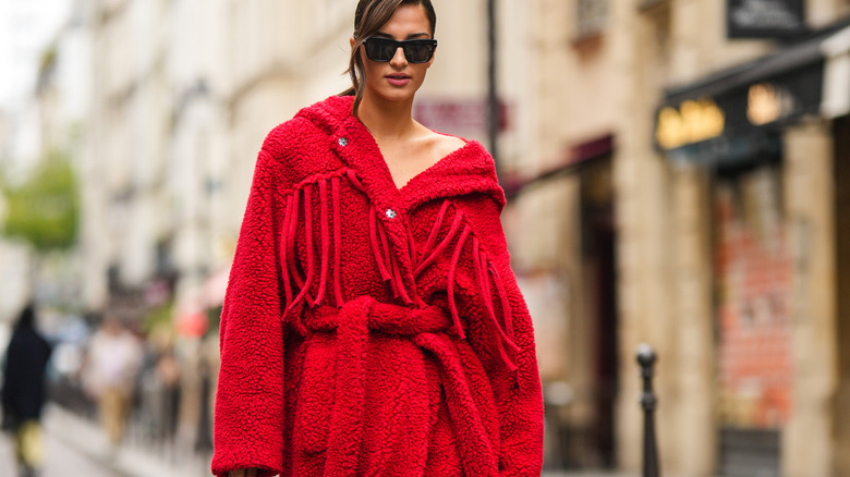 Woman wearing big red coat on street