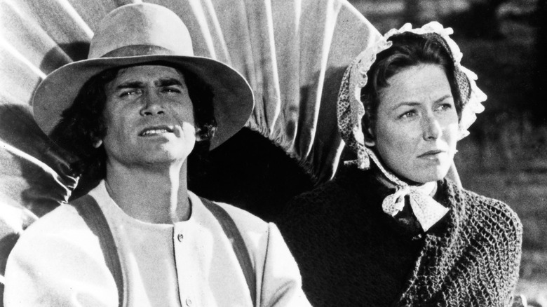A black-and-white photo of Michael Landon and Karen Grassle on the set of 'Little House on the Prairie'