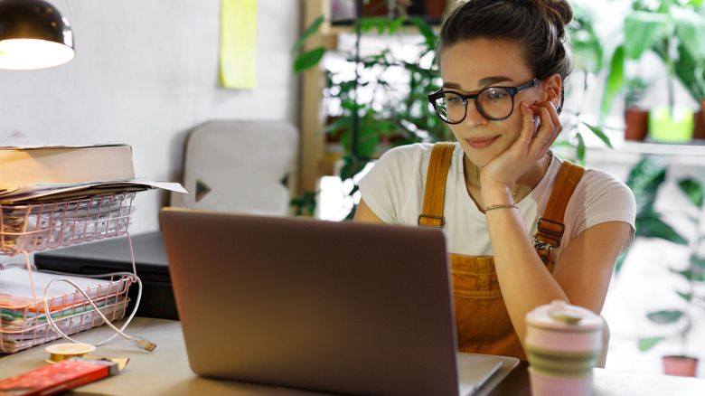 Woman working next to her coffee