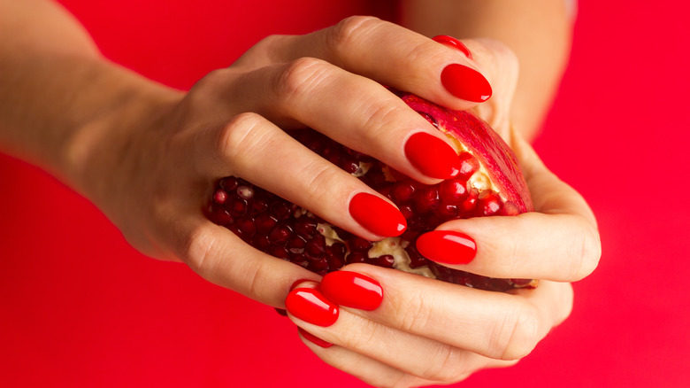 A woman wearing red nail polish 