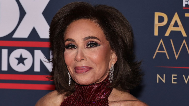 Jeanine Pirro smiling while wearing a red dress at the Patriot Awards.