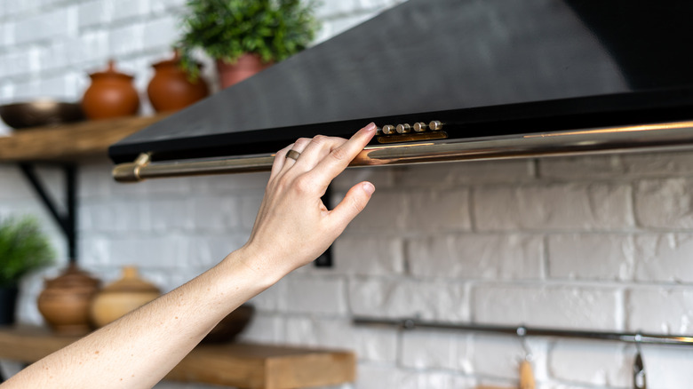 Woman's arm on range hood