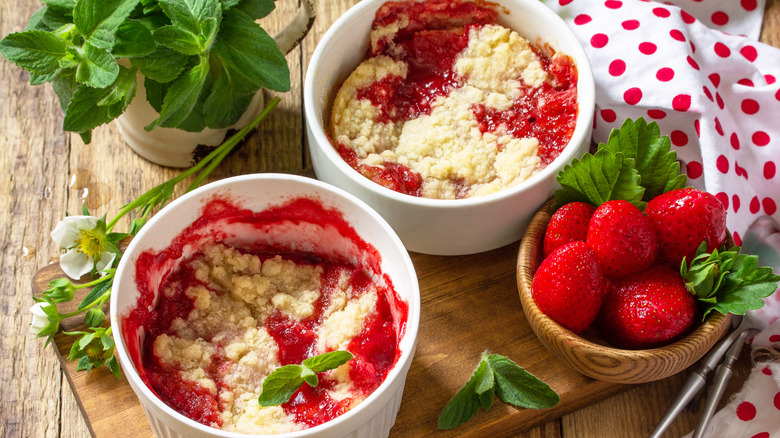 Two strawberry cobblers with extra strawberries