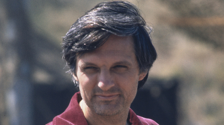 Alan Alda smiling on the set of 'M*A*S*H'