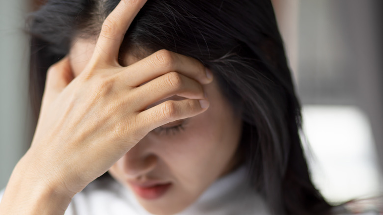 woman holding head