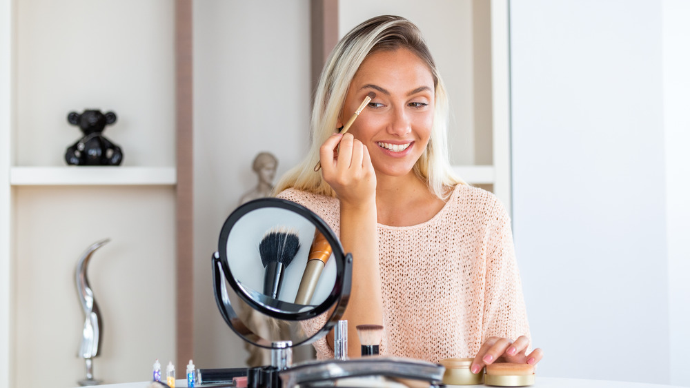 Woman applying eyeshadow