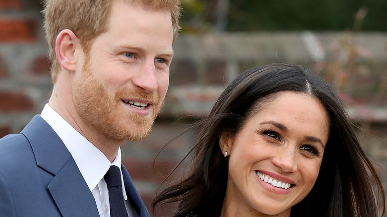 Meghan and Harry smile for photographers