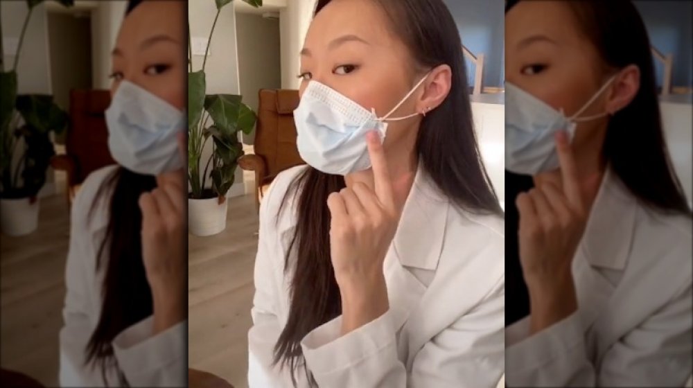 Olivia Cuid adapating a surgical mask