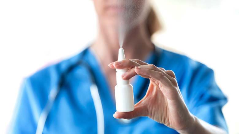 woman using nasal spray 