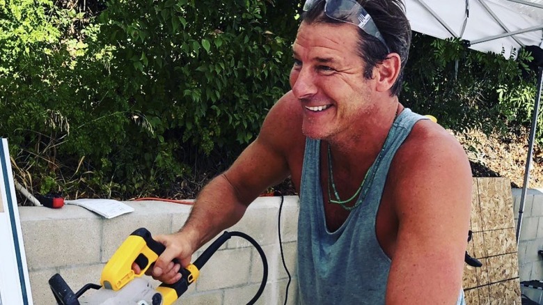 Ty Pennington sawing some wood