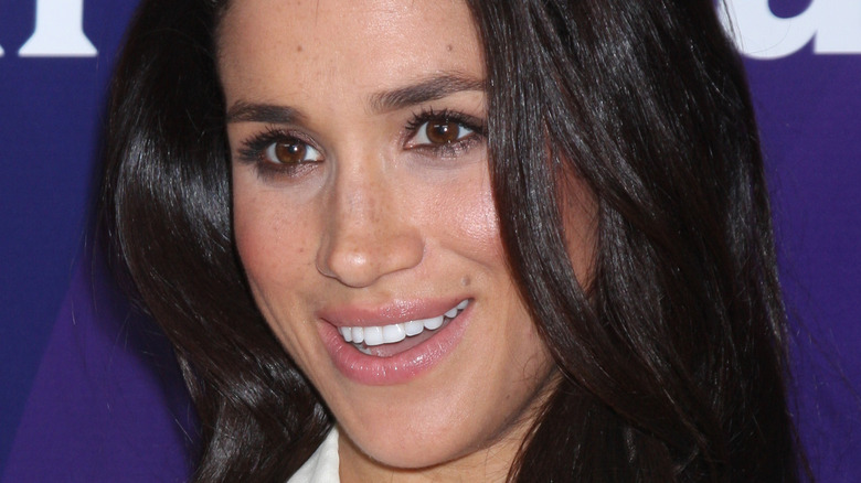 Meghan Markle smiling on the red carpet