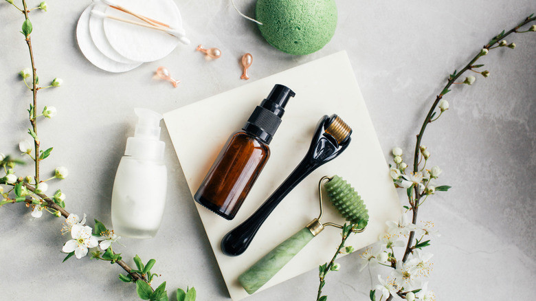 a set of beauty tools and flowers