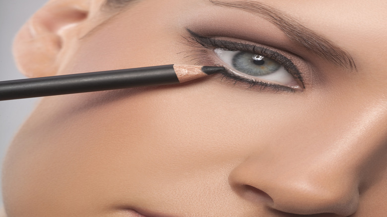 Woman applying eyeliner