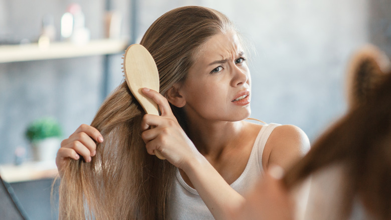 woman brushing tangled hair