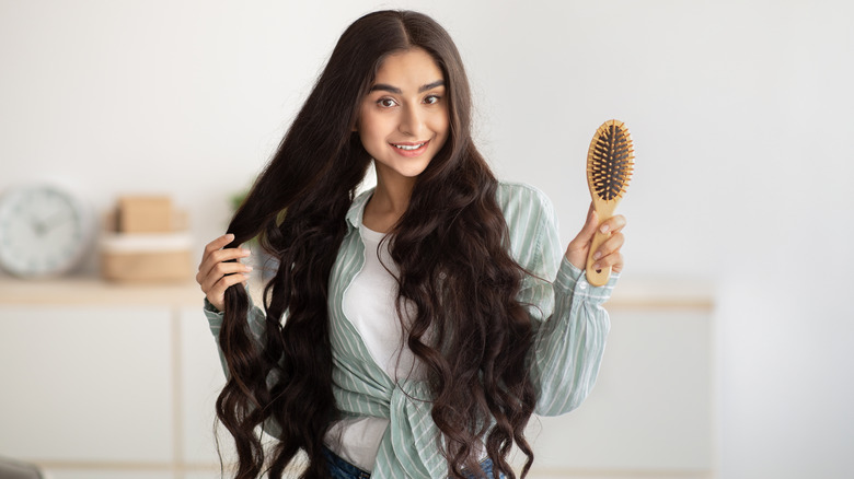 Woman long hair holding brush