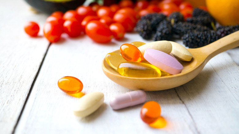 Multivitamin tablets on spoon 