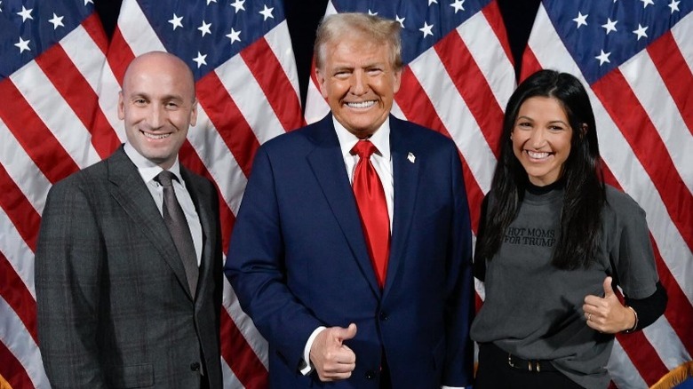 Stephen Miller, Donald Trump, and Katie Miller pose together with thumbs up (2024)