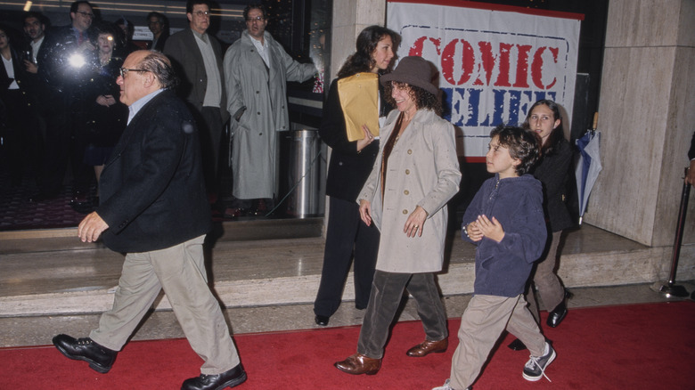 Danny Devito and Rhea Perlman walk the red carpet while two of their children follow closely behind