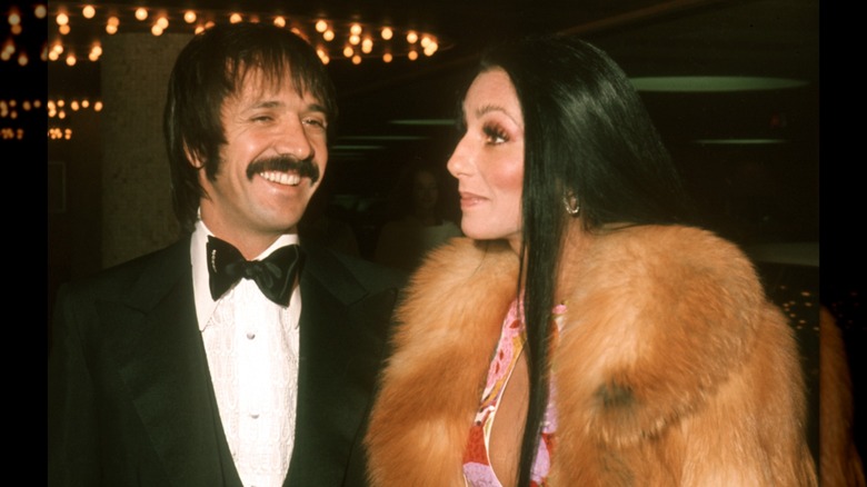 Sonny Bono laughing and Cher looking to the left