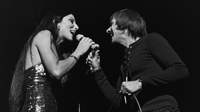 Cher and Sonny Bono looking at each other and singing