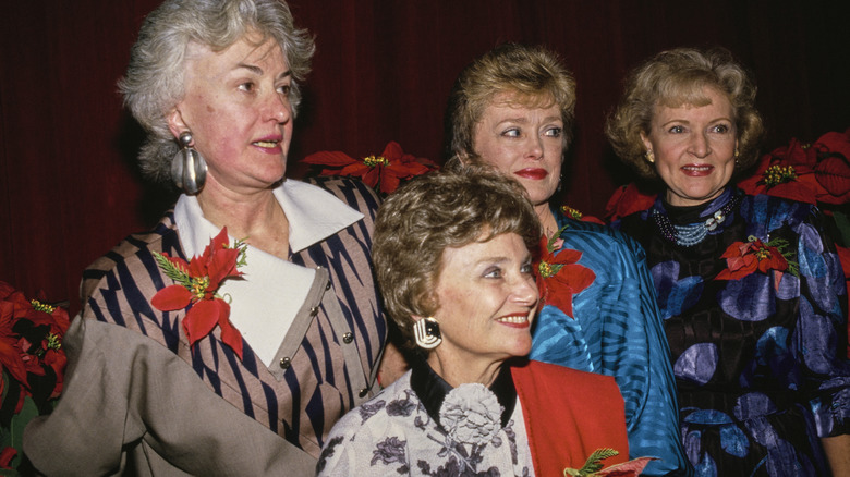 Bea Arthur, Estelle Getty, Rue McClanahan, and Betty White, all four with a red flower pinned to their chest, attend the 46th Annual Golden Apple Awards in December 1986.