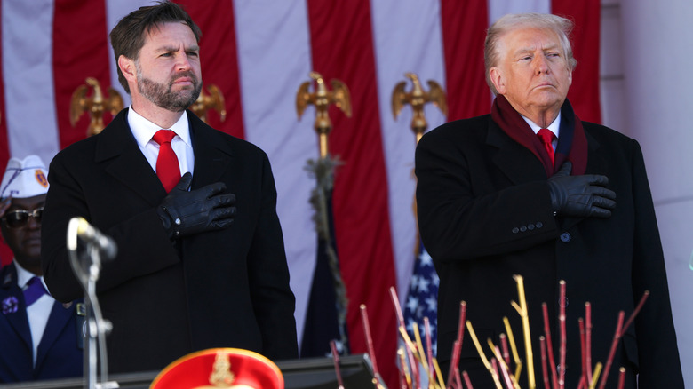 JD Vance and Donald Trump standing with their hands on their hearts