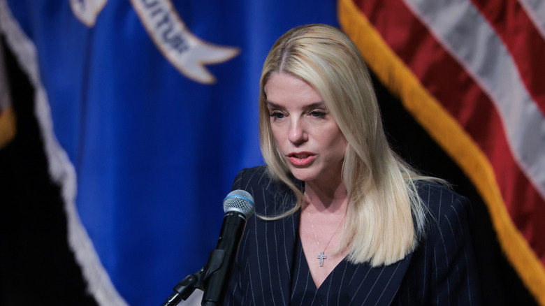 Pam Bondi speaks into a microphone