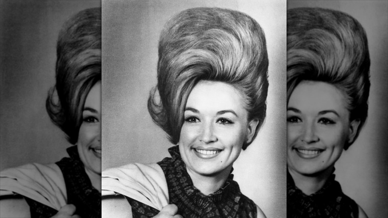 Dolly Parton posing with a tall, '60s beehive hairdo